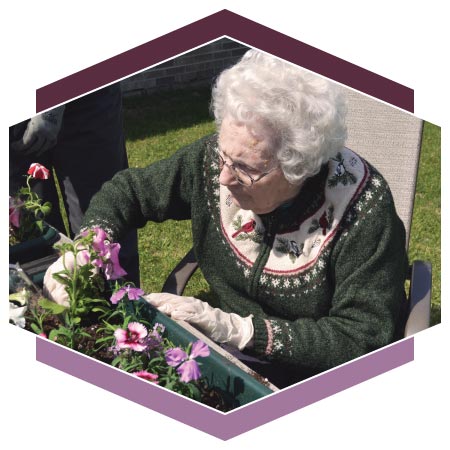 Resident tending to flower garden