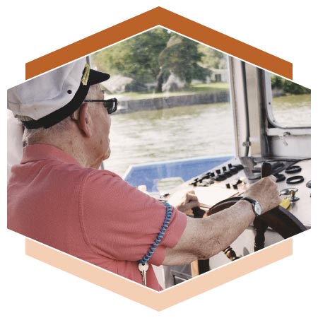 Resident on field trip driving a boat